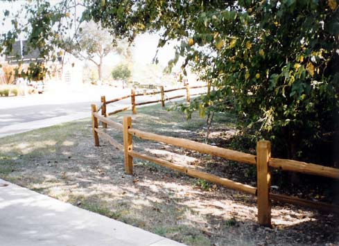 2 rail split cedar fence with posts around driveway