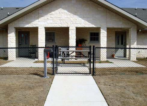 black chain link fence with gate to home