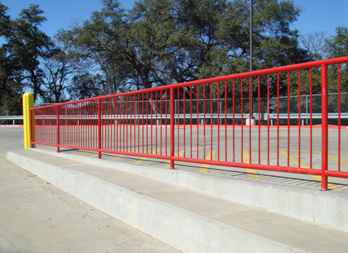 bright red handrail in parking lot