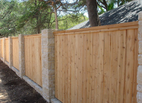 cedar wood fence with split rail top and stone beams