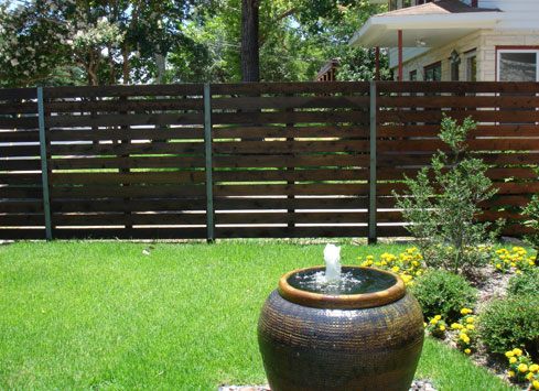 horizontal stained wood fence with metal posts