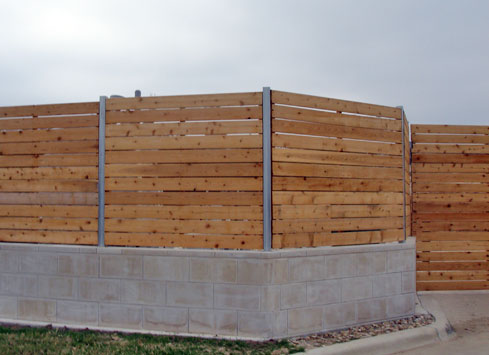 horizontal-wood-fence-with-metal-posts-on-top-of-concrete-base