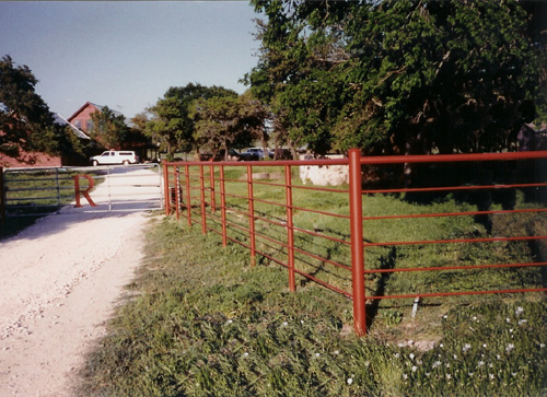 red painted steel ranch fence entrance
