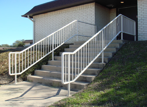 white metal handrail going down steps
