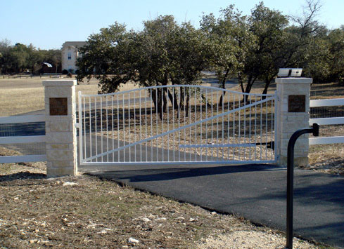 white metal swing out driveway gate solar powered front view