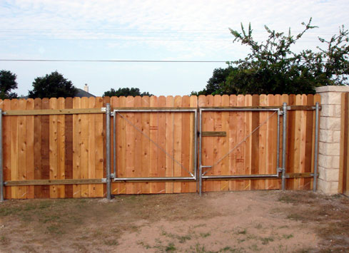 wood privacy fence with large gate